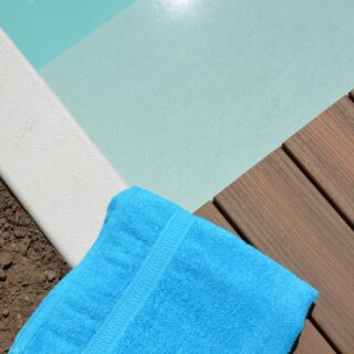 at-the-pool-blue-towel-on-the-edge-of-the-pool-2022-01-04-17-55-13-utc